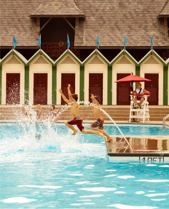 Children jumping into pool.